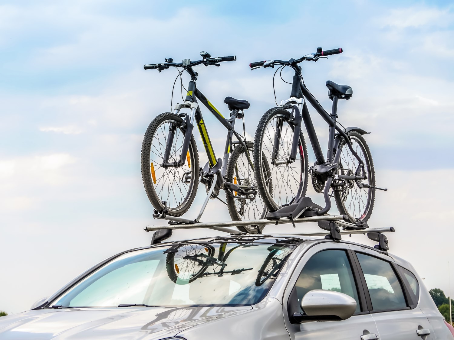 car with roof rack holding bikes