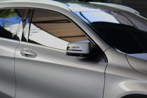 Vehicle interior protected from UV exposure by ceramic window tint