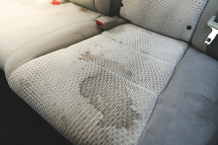 Dirty vehicle interior before professional detailing