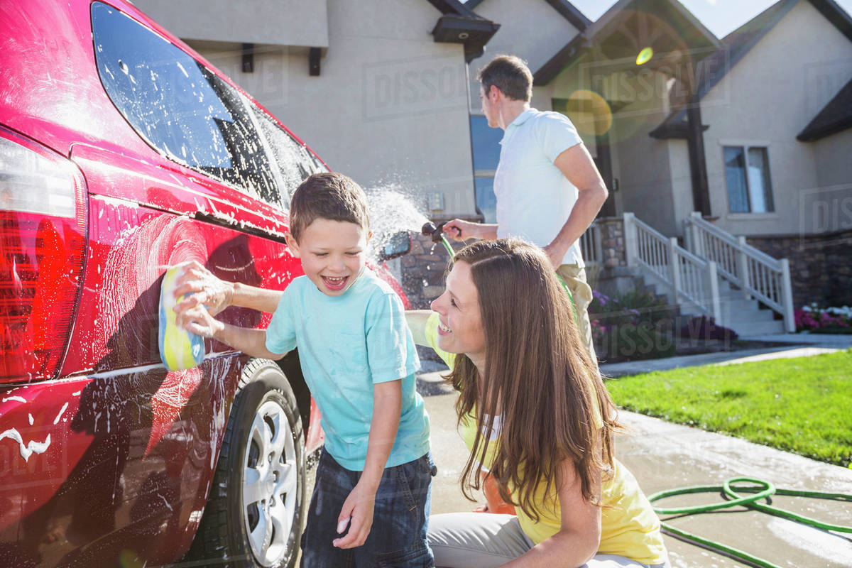 Family washing their minivan together