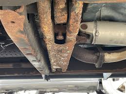 Rust developing on an older pickup truck frame and underbody