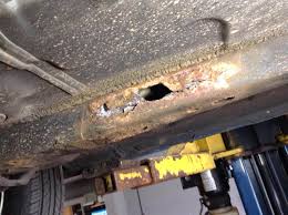 Vehicle underbody showing significant rust and corrosion